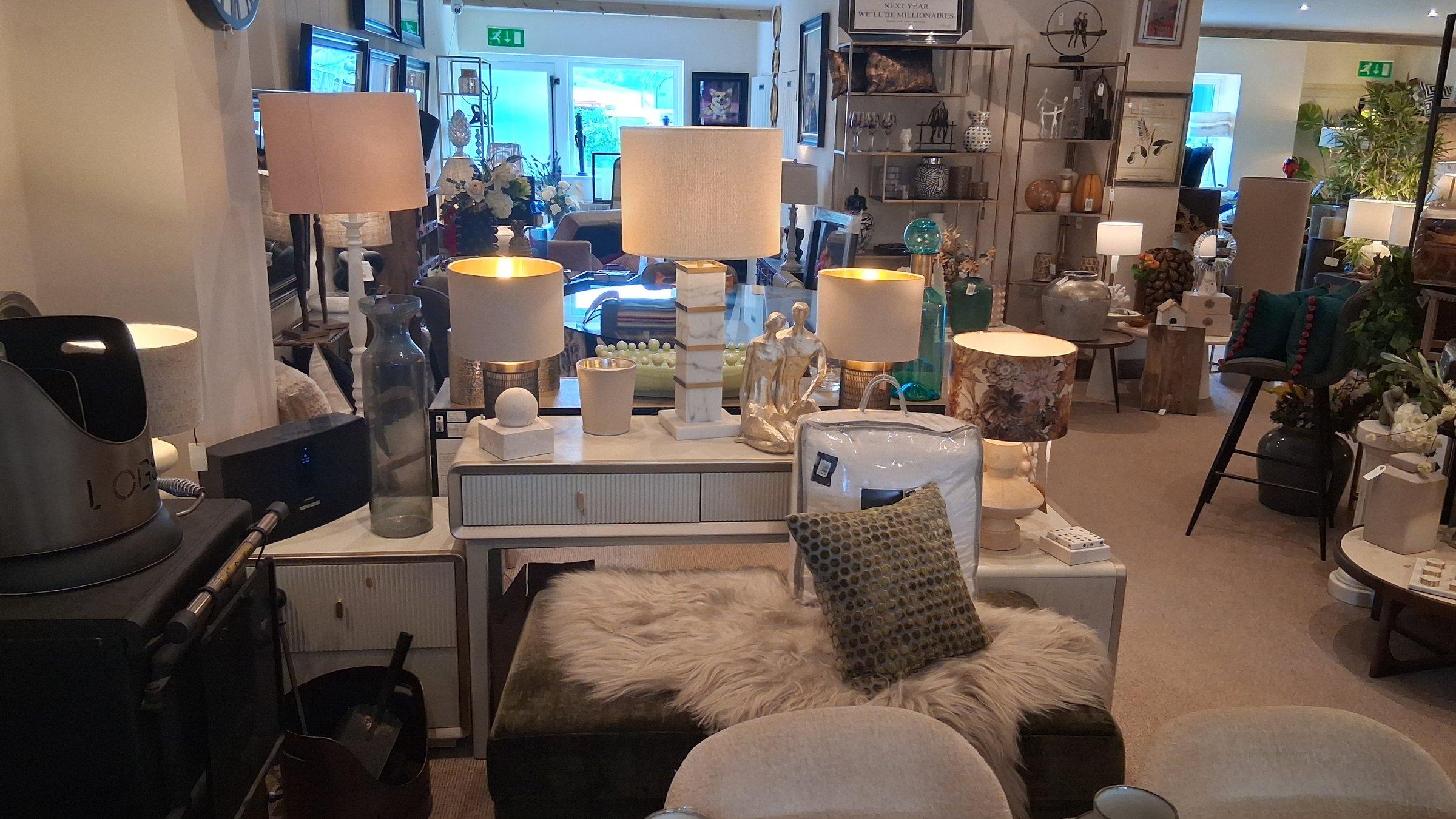 Table lamp display on a console with marble lamp bases and linen shades