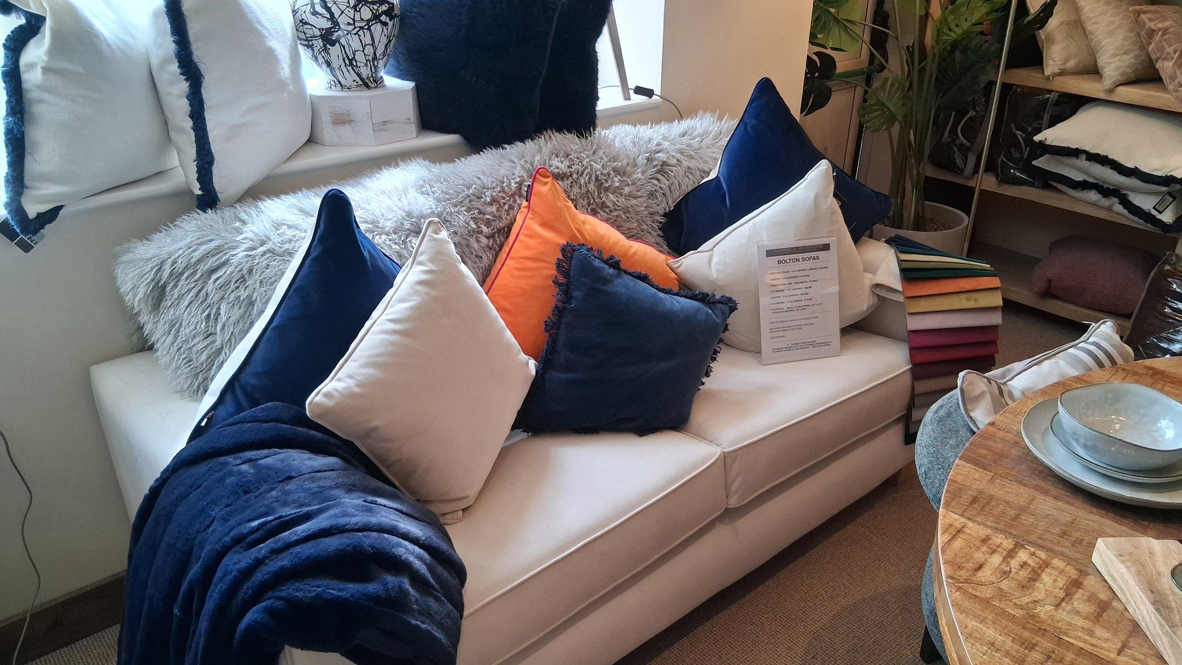 Cream Bolton sofa styled with navy, orange and cream cushions